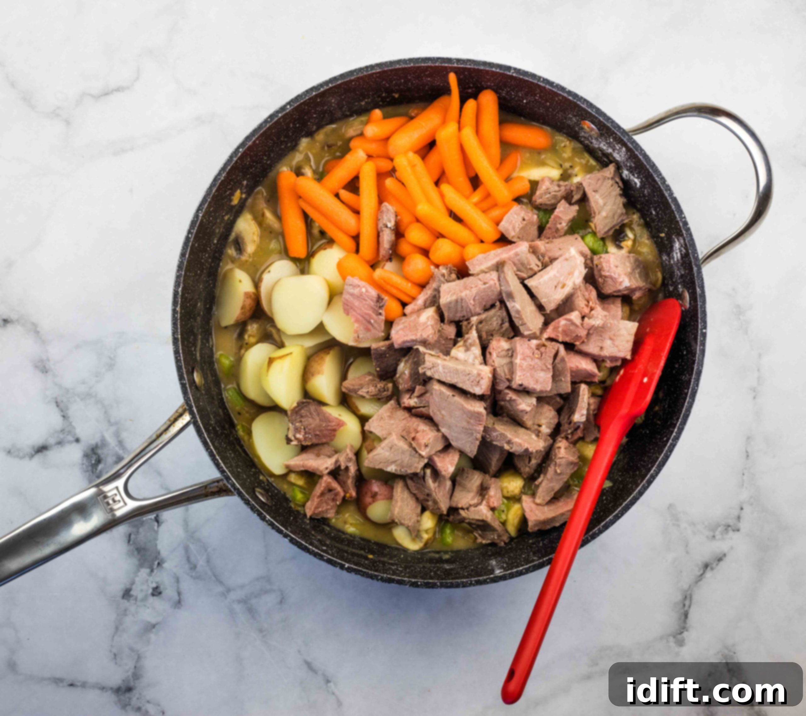 Carrots and beef added to the leftover roast beef stew in the skillet.