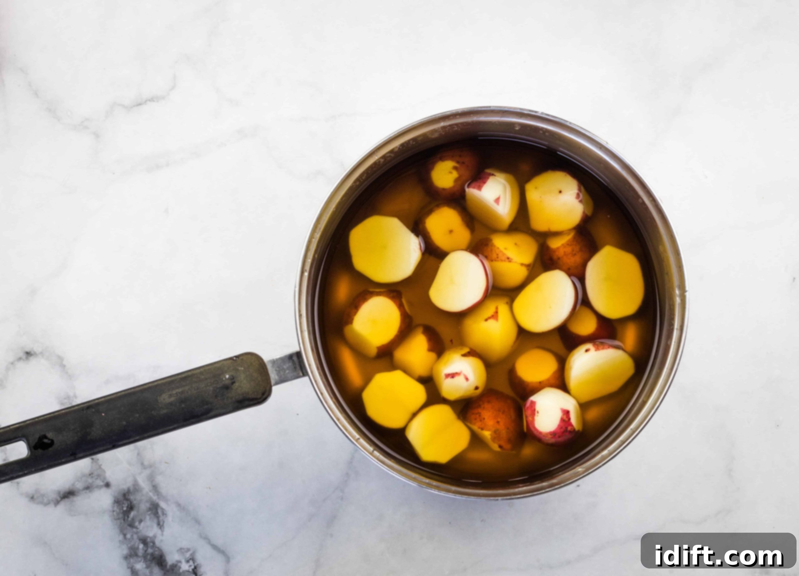 Simmering potatoes in beef broth.