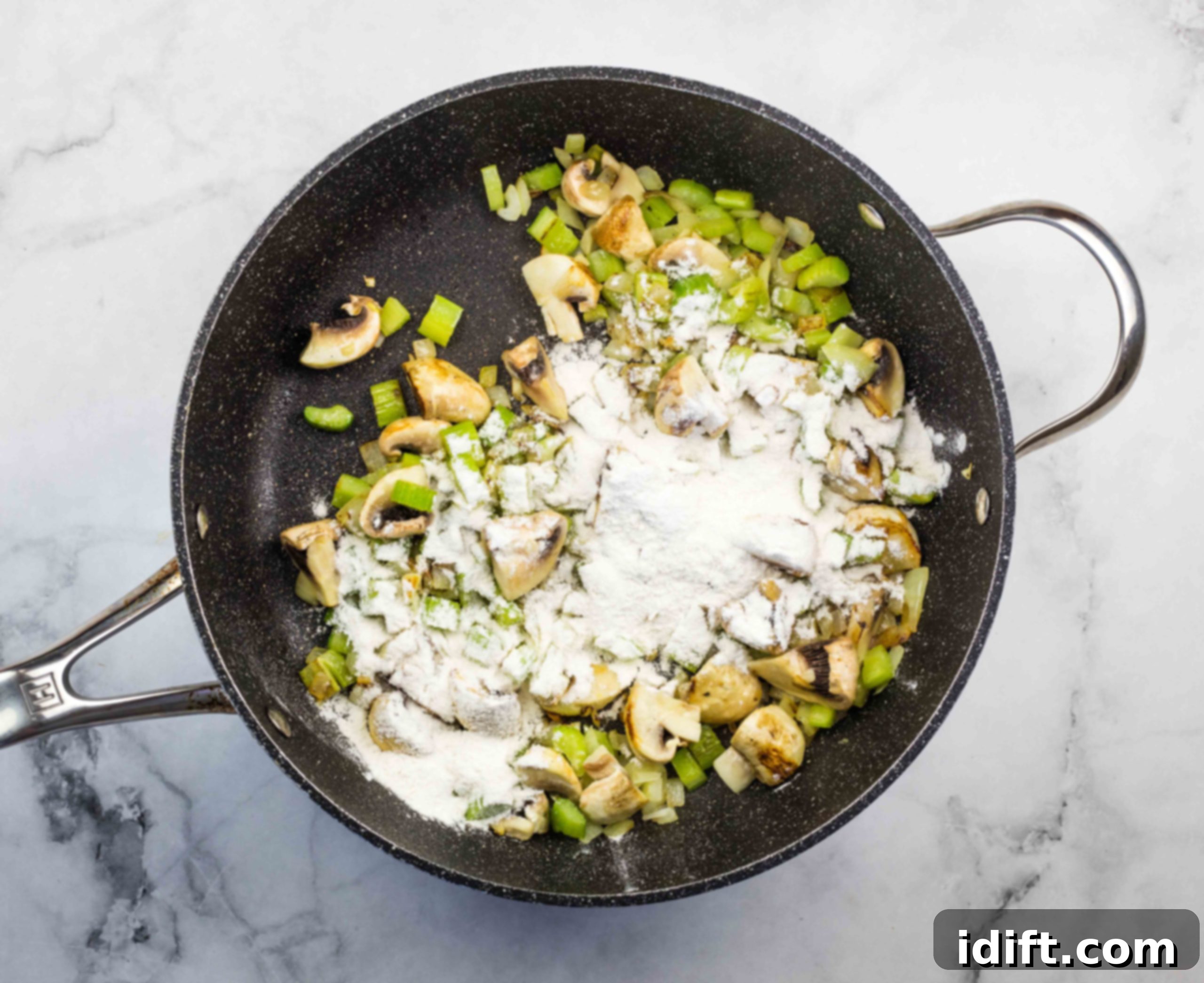Flour added to the vegetables to build the gravy for leftover roast beef stew.