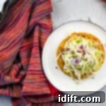 fully loaded chicken tinga tostada on a plate