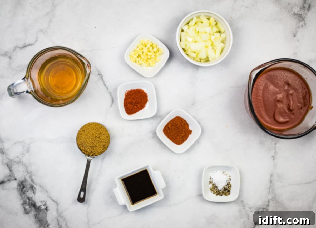Chipotle Bourbon BBQ Sauce 3 Selection of fresh ingredients laid out, including bourbon, diced onion, garlic, tomato sauce, brown sugar, Worcestershire sauce, paprika, and chipotle powder, ready to make homemade BBQ sauce.