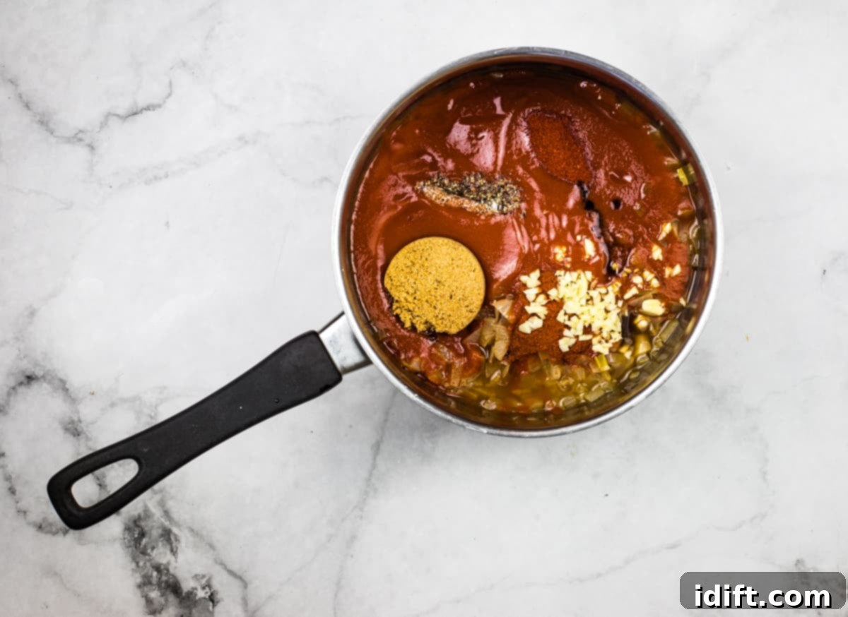 Chipotle Bourbon BBQ Sauce 5 All remaining ingredients for chipotle bourbon BBQ sauce added to the pot with the reduced bourbon and onions, ready for simmering and blending.