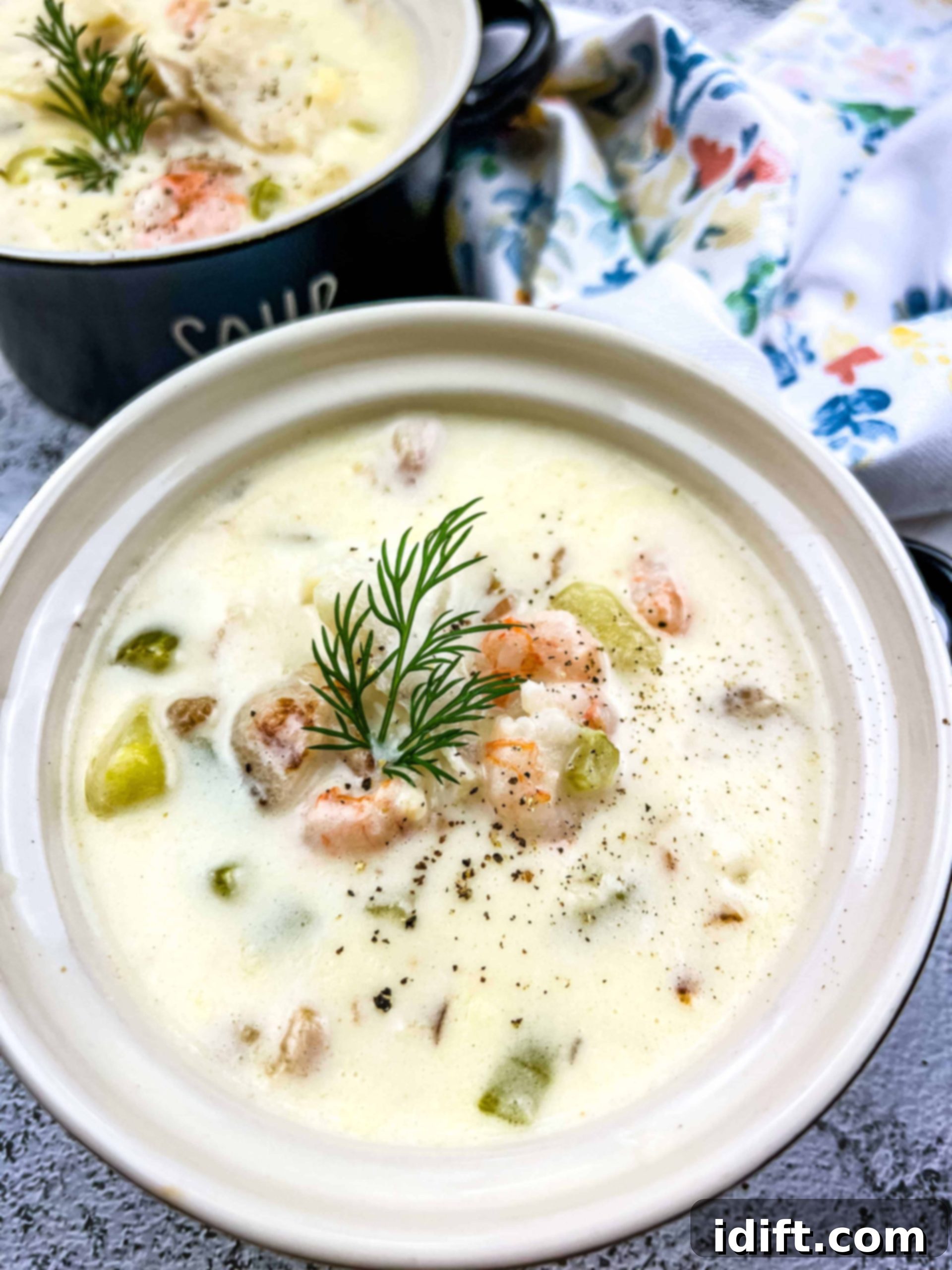 seafood chowder in a bowl with a second bowl in the background