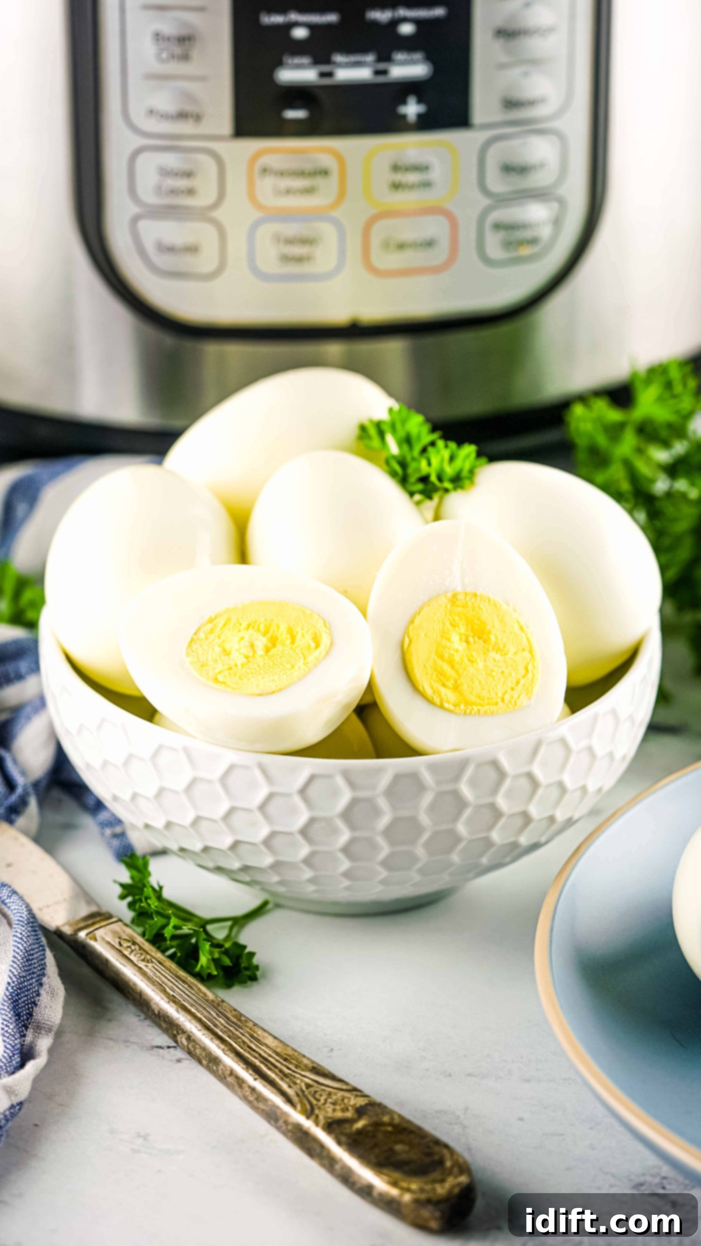 Perfectly cooked hard-boiled eggs in front of an Instant Pot, ready to be peeled and enjoyed.