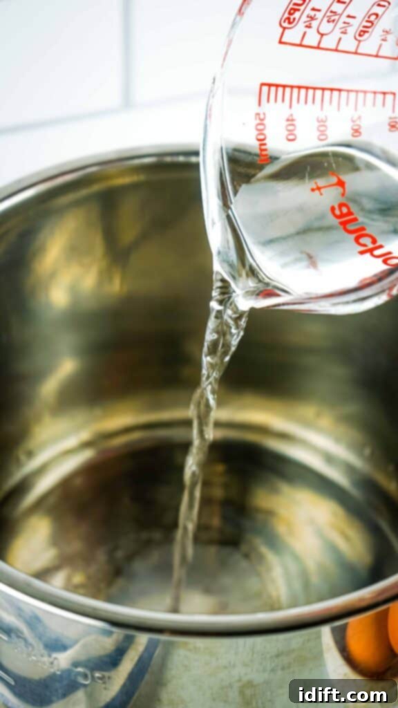 Water being added to an Instant Pot with eggs already placed inside.