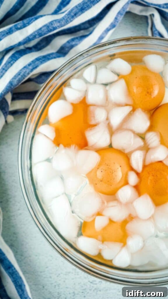 Cooked hard-boiled eggs chilling in a bowl of ice water after being removed from the Instant Pot.