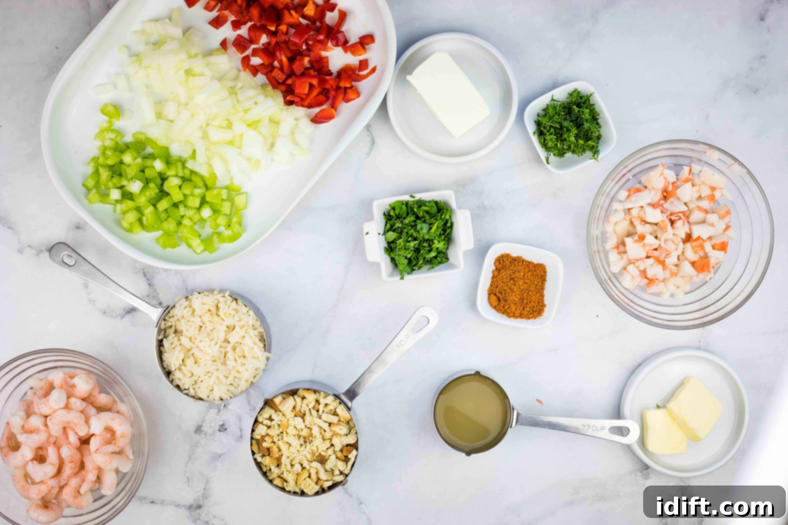 Various ingredients for seafood stuffing, neatly prepped and arranged on a counter.
