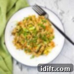 Chicken Fried Rice made on the blackstone griddle on a white plate