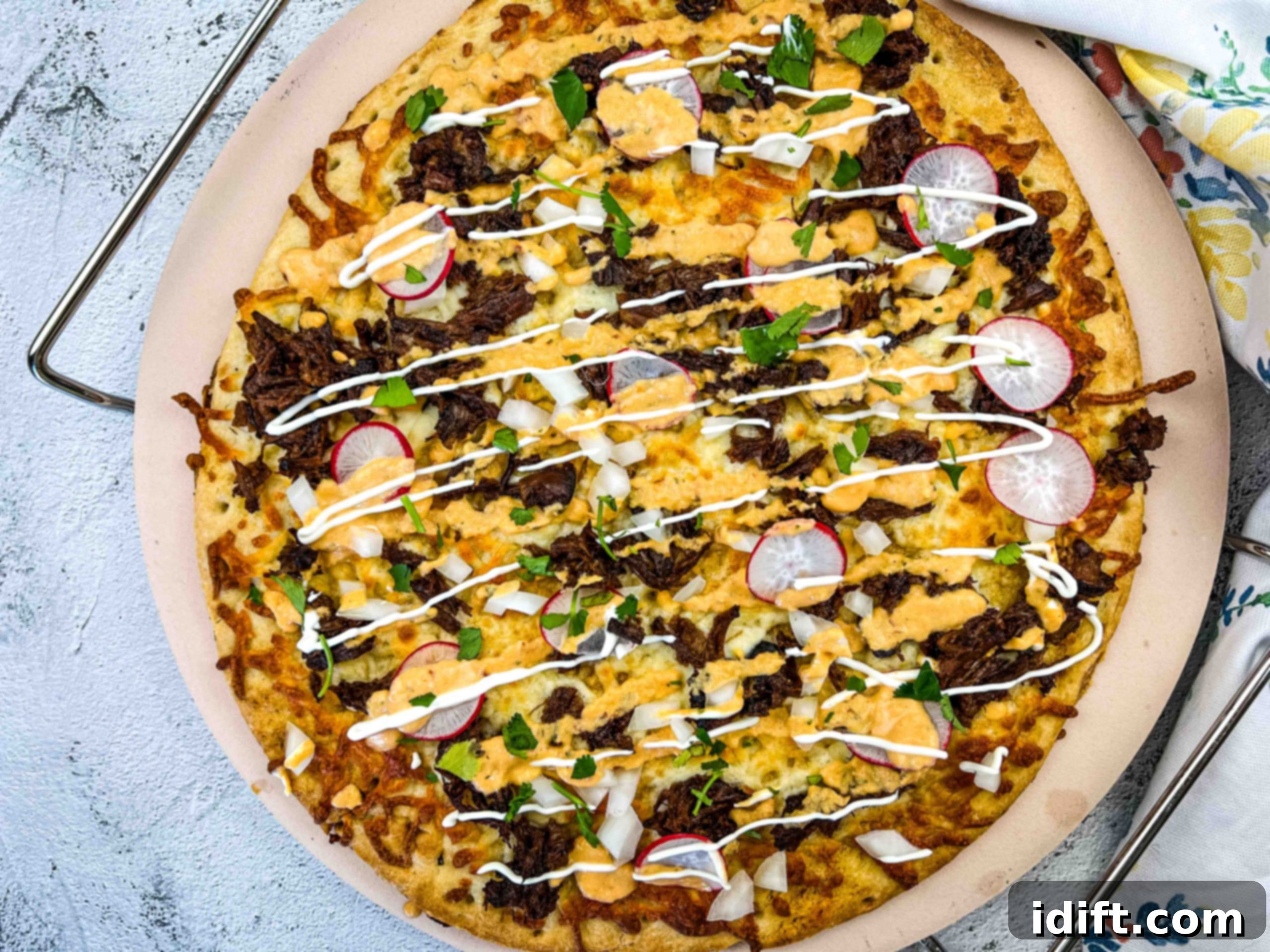 garnished birria pizza ready for serving