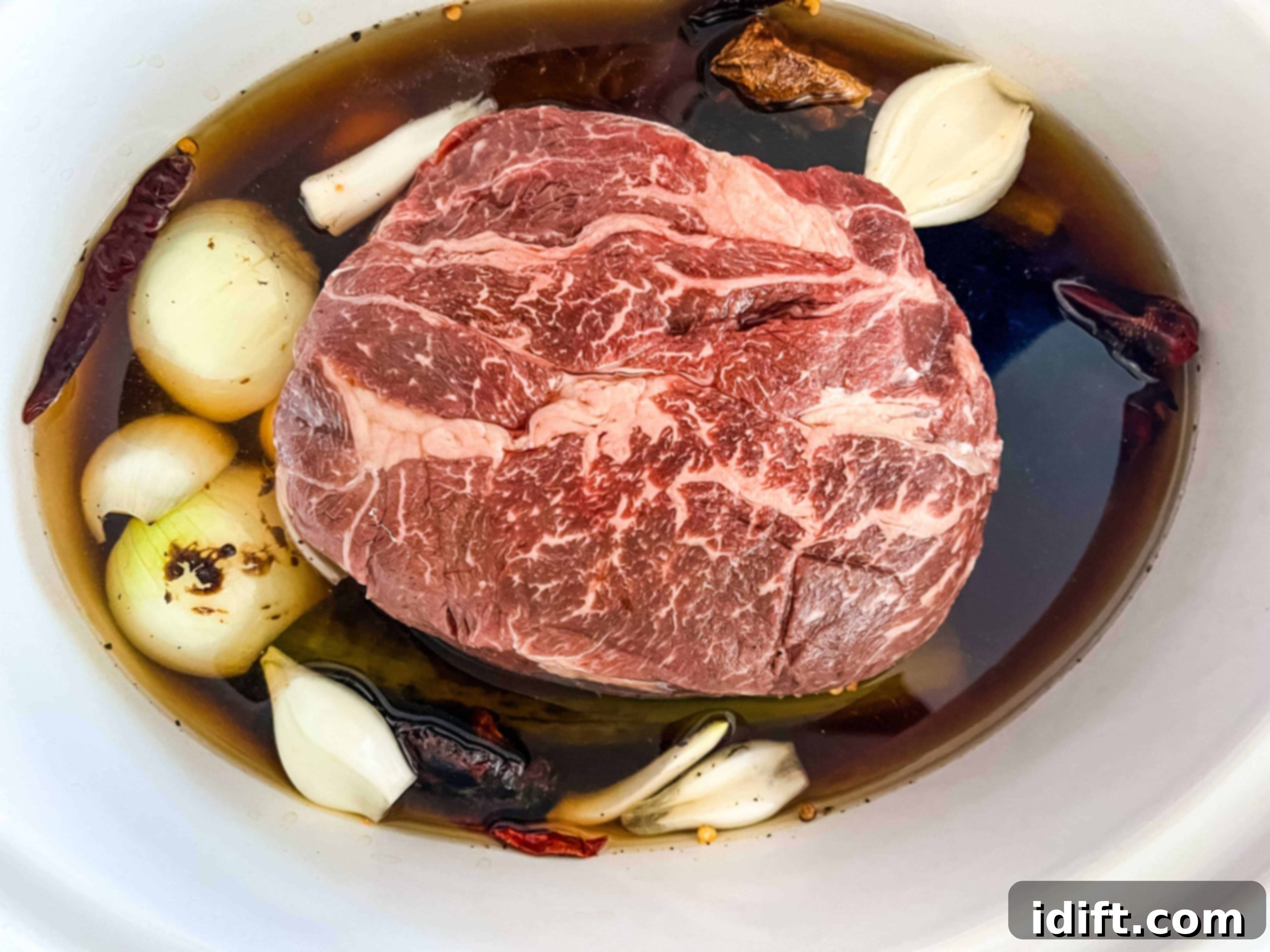 Tender Slow Cooker Birria de Res 6 All birria ingredients placed into the slow cooker for cooking.