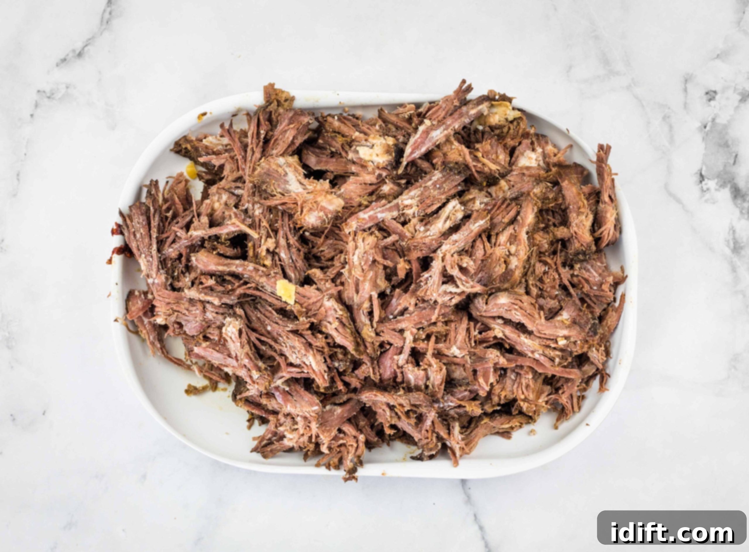 Tender Slow Cooker Birria de Res 7 Shredded birria de res beef, tender and ready to serve.