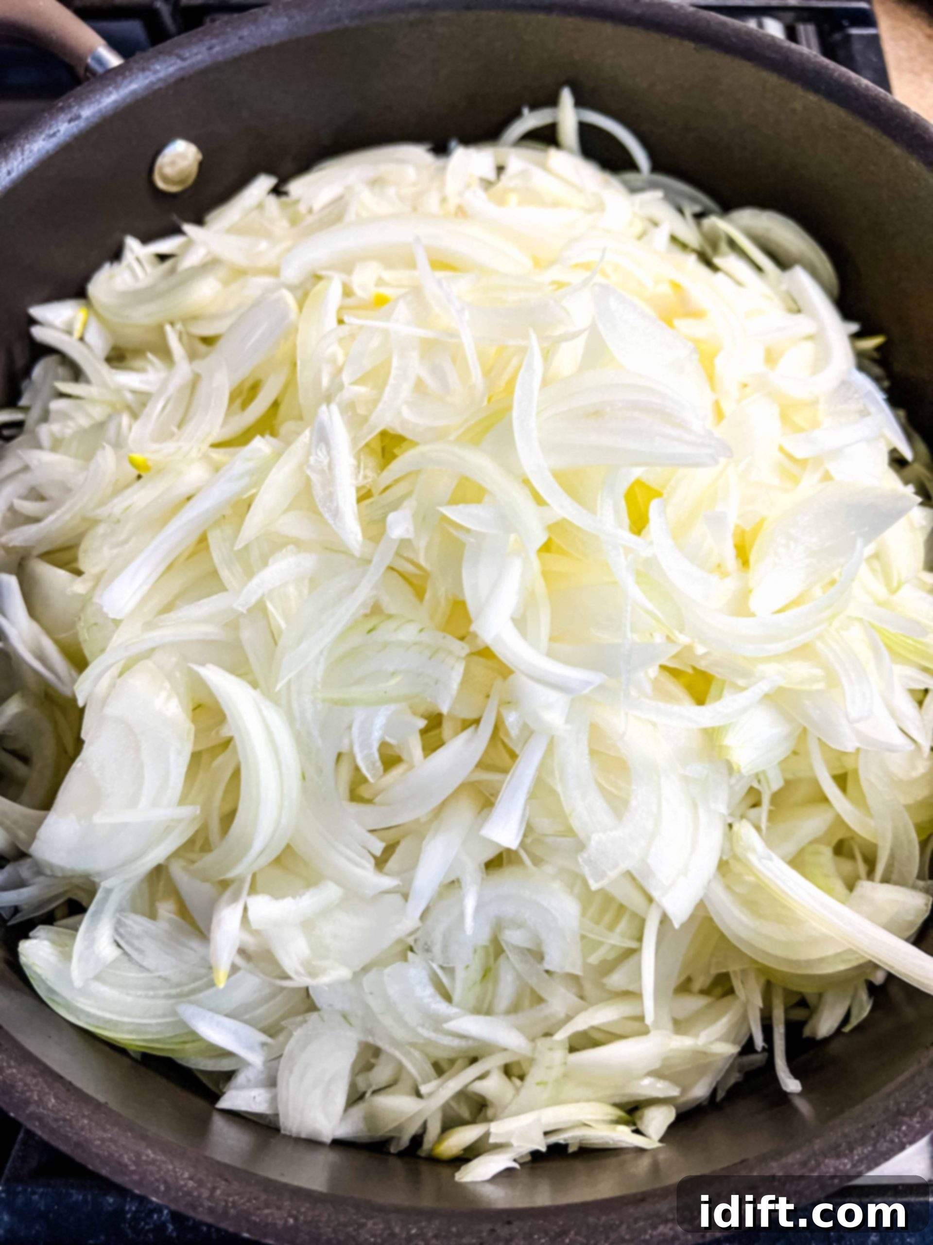 a mountain of onions in a skillet to make caramelized onions