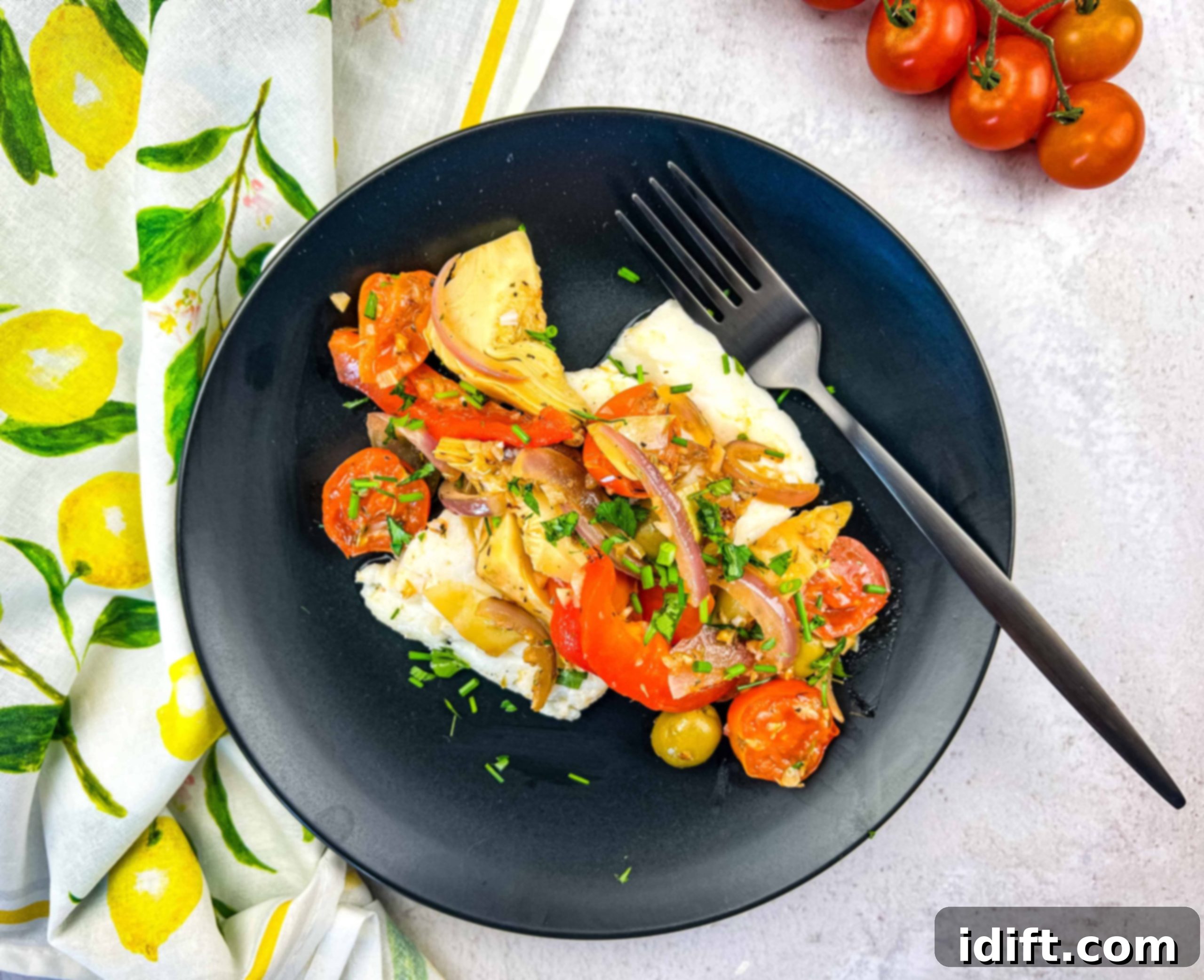 The finished Mediterranean cod dish, with pan-fried cod nestled among vibrant vegetables, ready for serving.