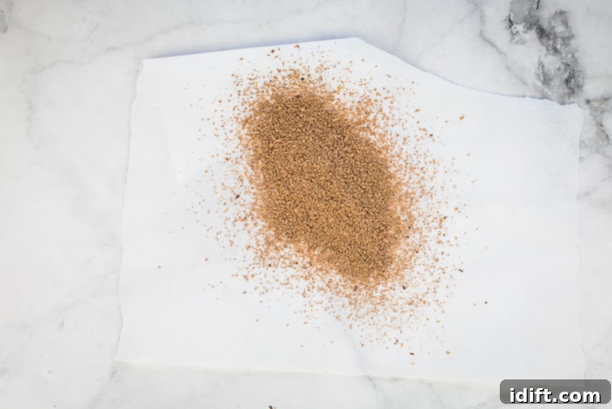 Delicate chocolate shavings sprinkled on top of a serving of Dulce de Leche Mousse in a glass.