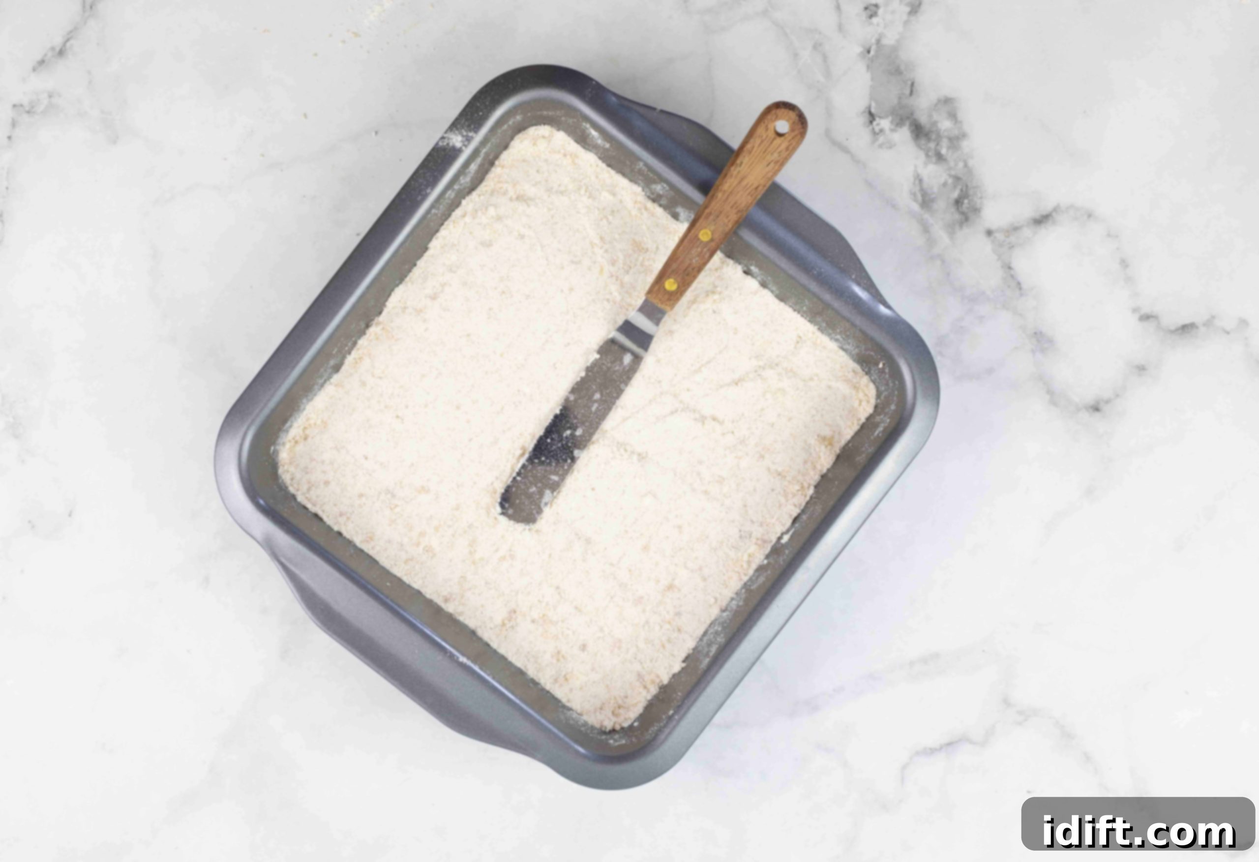 press the crumb mixture into the baking pan to make maple pecan pie bars