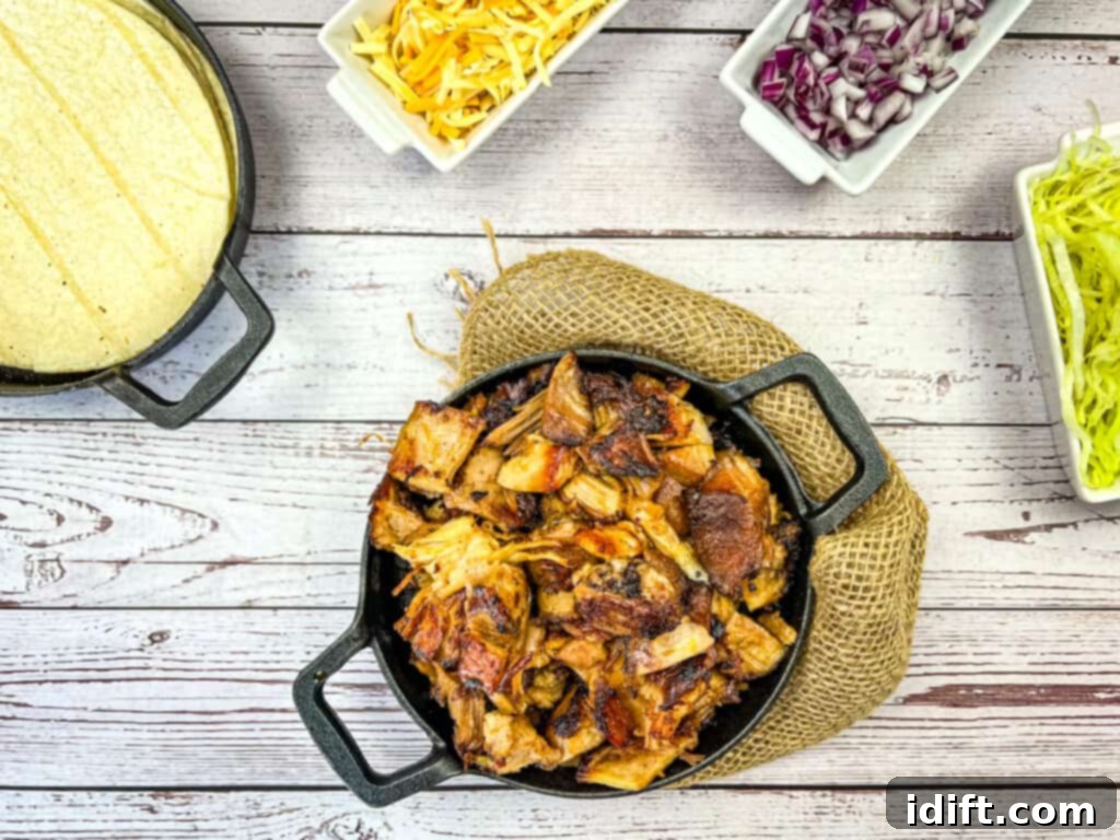 Ultimate Dutch Oven Pork Carnitas 3 instant precision dutch oven carnitas on a cast iron skillet with taco fixings