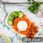 Dreamy Garlic Sauce 4 garlic dipping sauce in a bowl with veggies on the side.