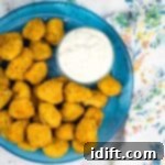 Crispy Air Fryer Popcorn Chicken 4 popcorn chicken on a plate with dipping sauce