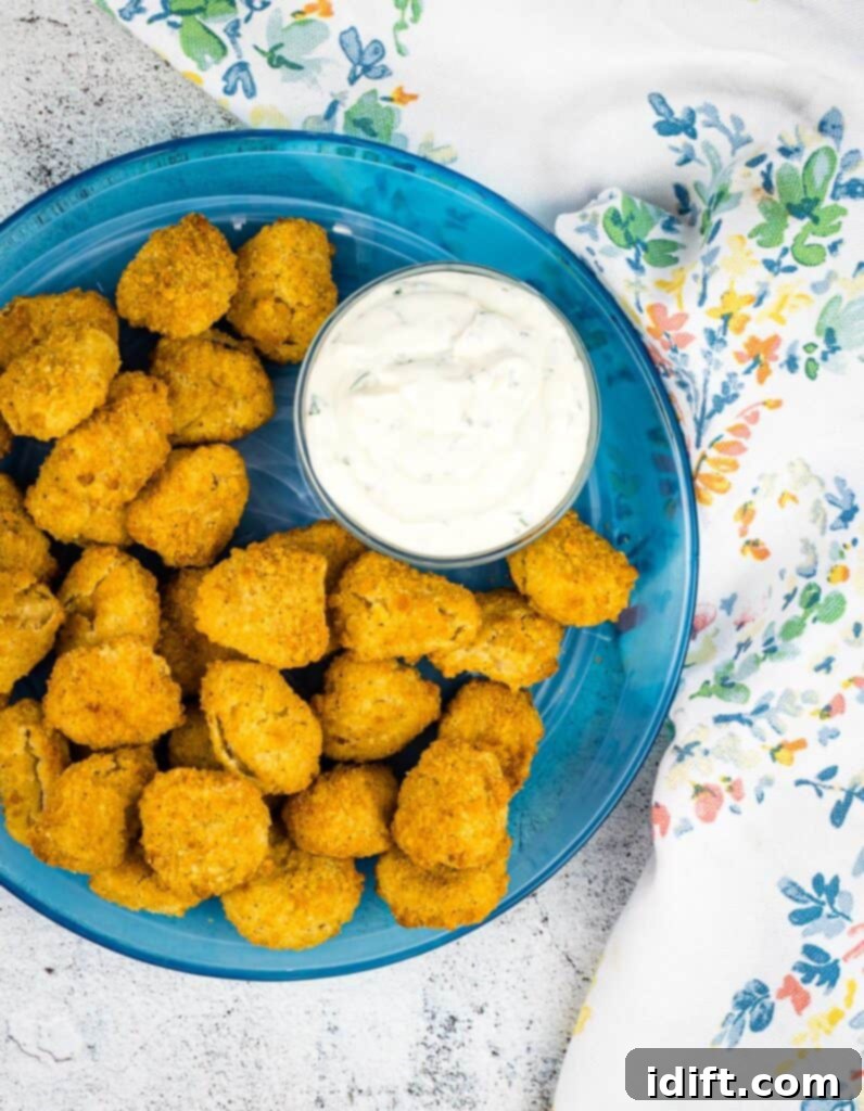 Crispy Air Fryer Popcorn Chicken 5 popcorn chicken on a plate with dipping sauce