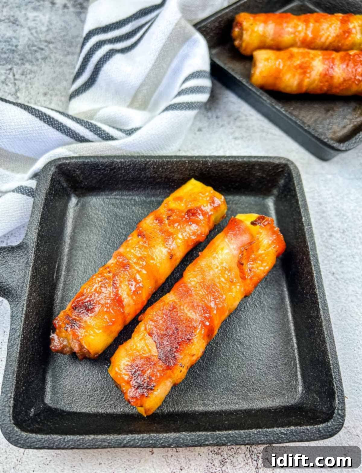 Smoked shotgun shells in black serving dishes, ready to be enjoyed.