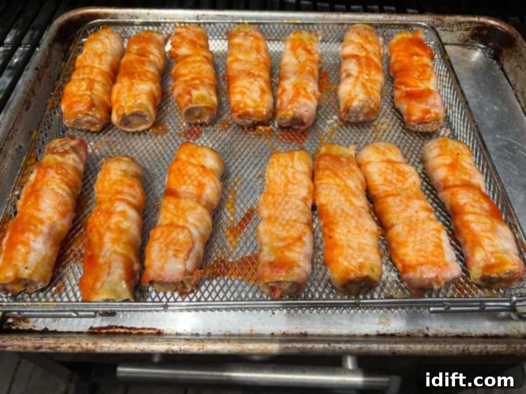 Sauced shotgun shells ready for their final smoke on the smoker rack.