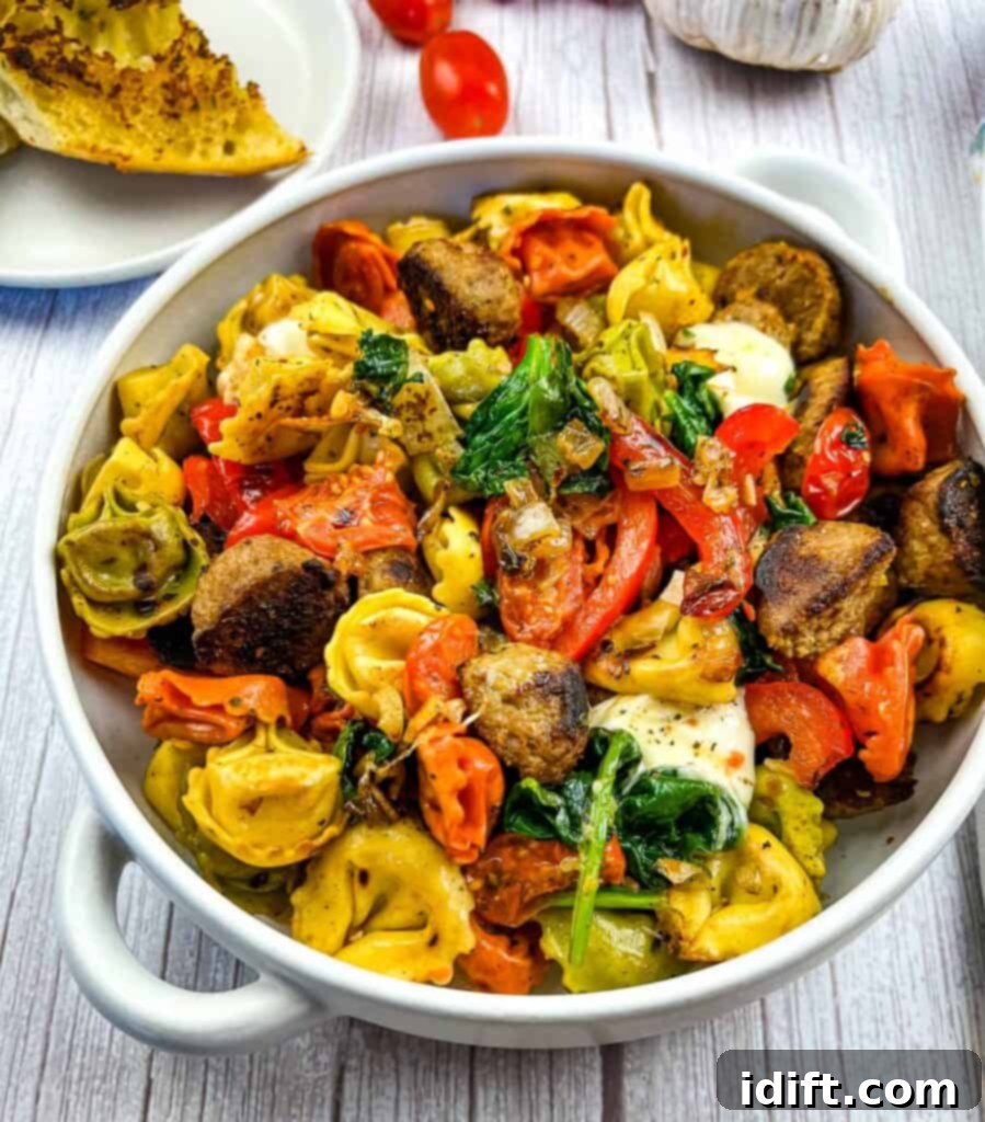 close up of blackstone tortellini with meatballs in a black bowl