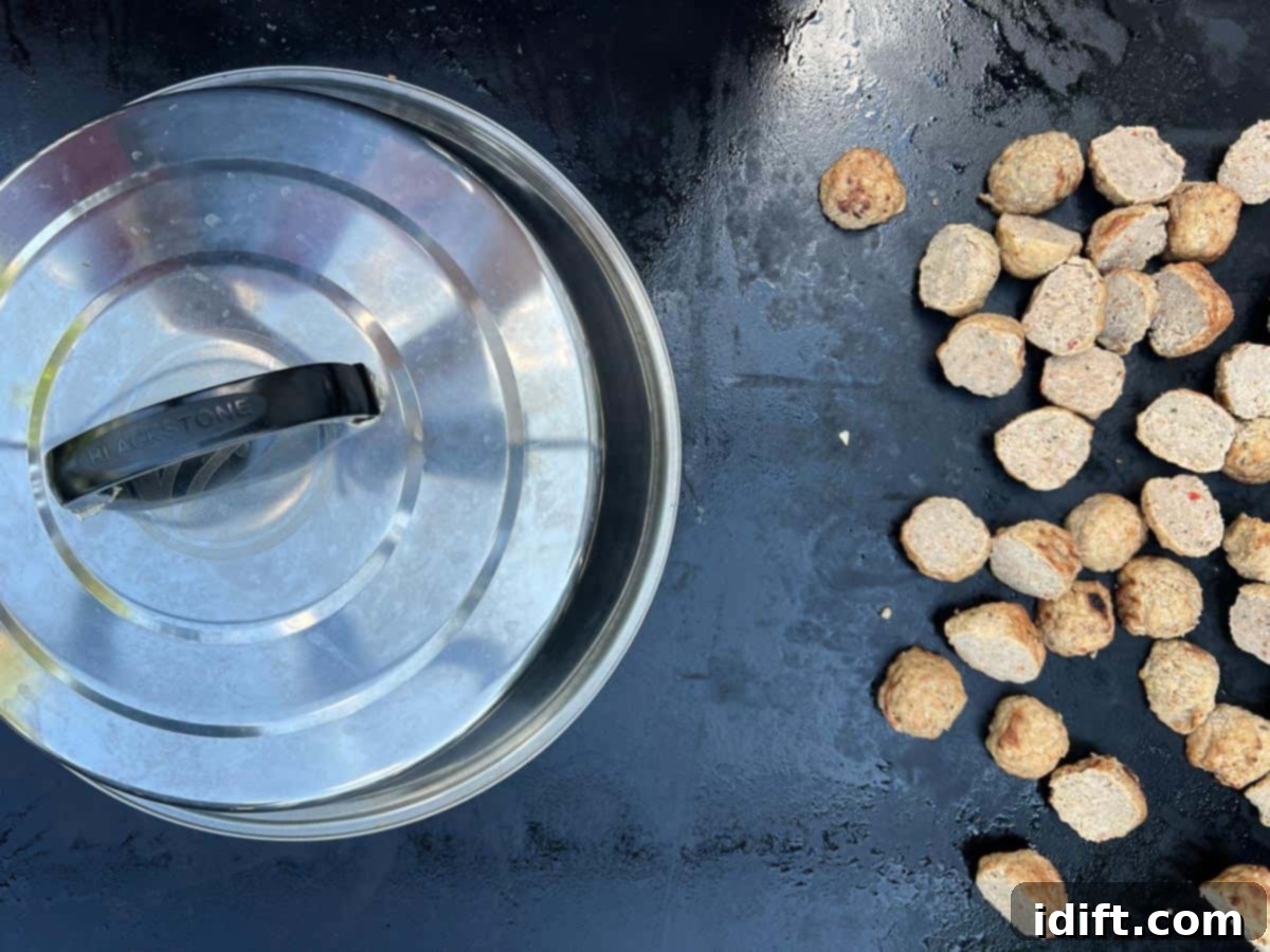 Tortellini under cooking dome with meatballs cooking on the side.