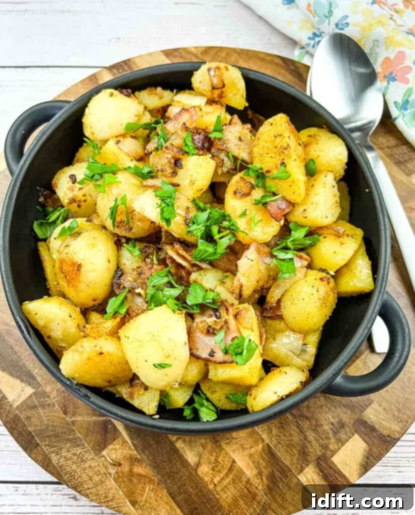 blackstone fried potatoes in a black dish on a white cutting board