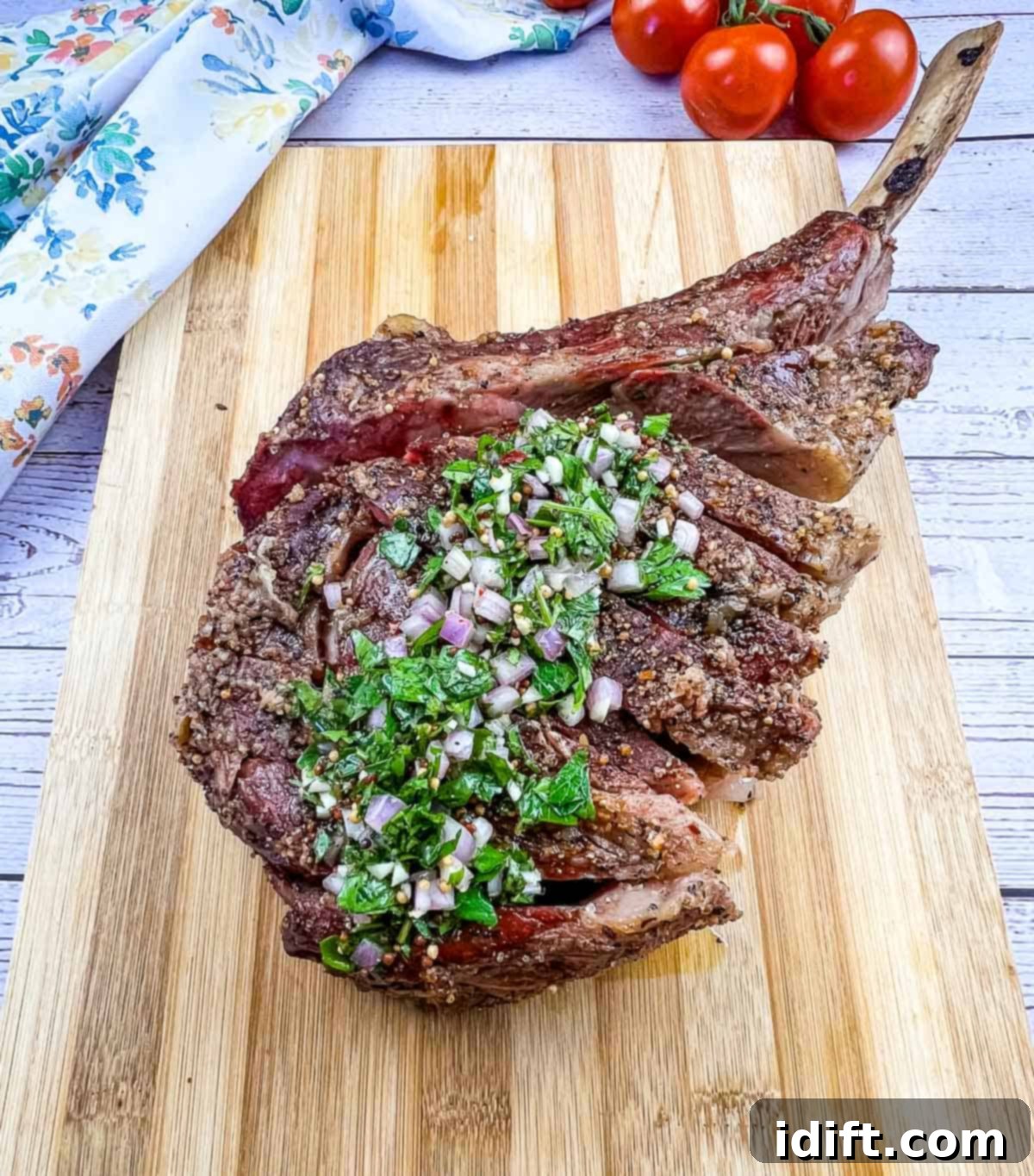 smoked tomahawk steak on a cutting board