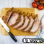 Slow-Smoked Pork Rack 11 carved smoked rack of pork on a cutting board, garnished