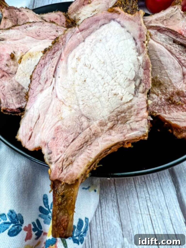 Slow-Smoked Pork Rack 12 smoked rack of pork carved and arranged beautifully on a plate, ready to be enjoyed