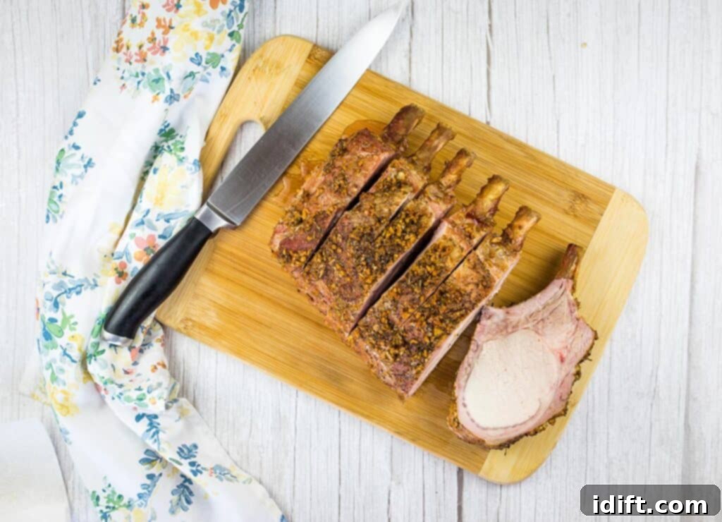 Slow-Smoked Pork Rack 3 carving smoked rack of pork on a wooden board with a knife