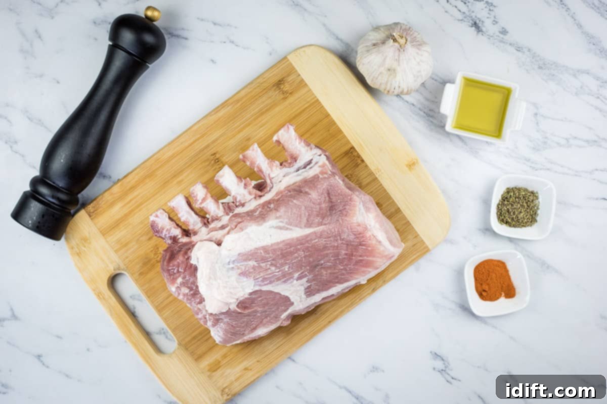 Slow-Smoked Pork Rack 5 smoked rack of ribs ingredients laid out on a countertop, including pork, garlic, and spices