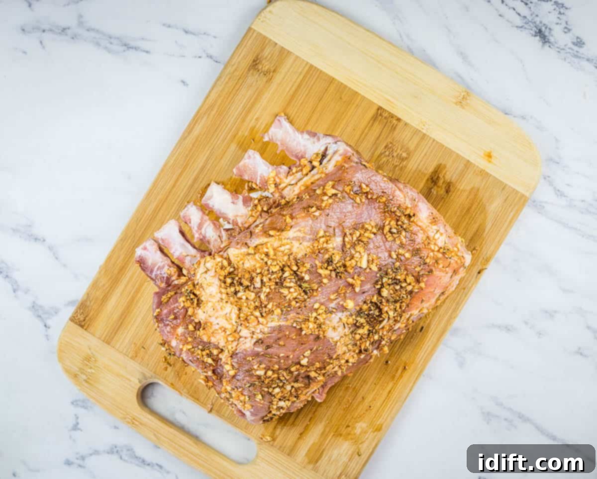 Slow-Smoked Pork Rack 7 raw rack of pork fully rubbed and prepared for the smoker