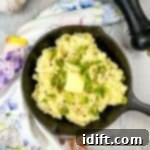 Fireside Mash 4 Smoked mashed potatoes in a black skillet, perfectly creamy.