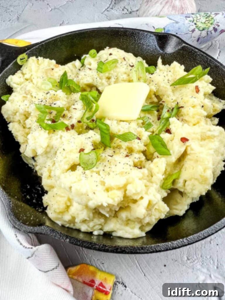 Fireside Mash 5 A vibrant, close-up shot of smoked mashed potatoes in a serving skillet, garnished and ready for a meal.