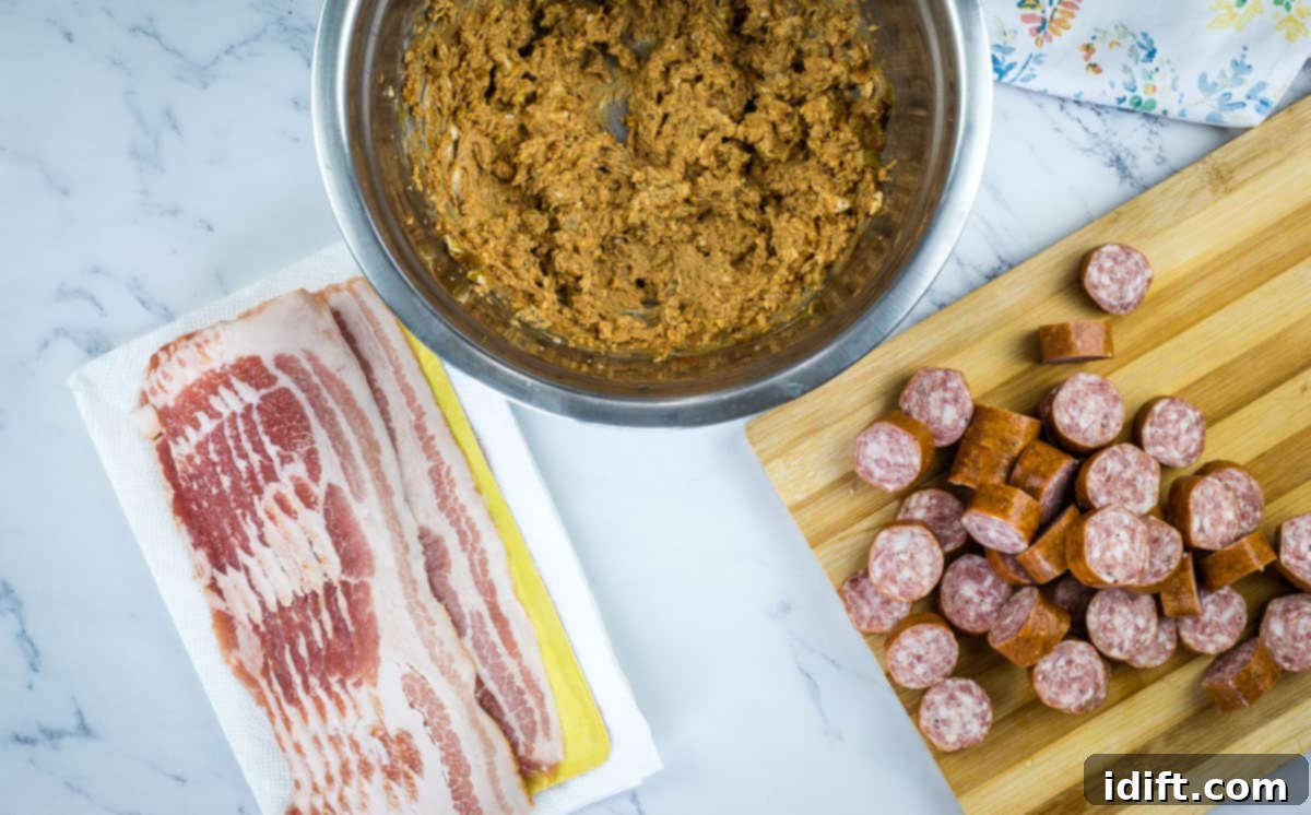 cream cheese filling in a bowl for making smoked pork shots, alongside sliced sausage