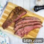 Slow-Smoked Ribeye Perfection 8 sliced smoked ribeye roast on a cutting board