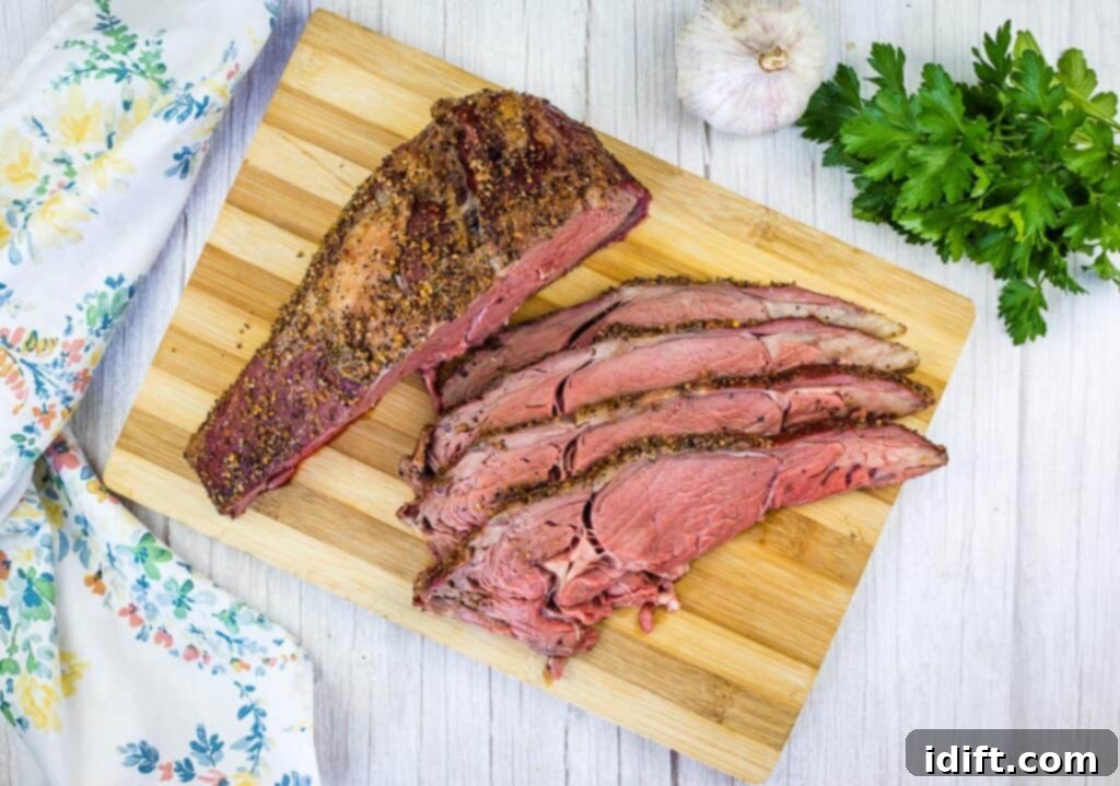 Slow-Smoked Ribeye Perfection 4 sliced smoked ribeye roast on a cutting board