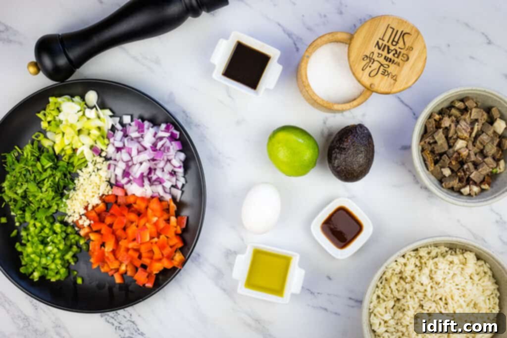 A beautifully arranged selection of fresh ingredients including colorful bell peppers, onions, garlic, brisket, rice, and sauces, all ready for making Brisket Fried Rice.