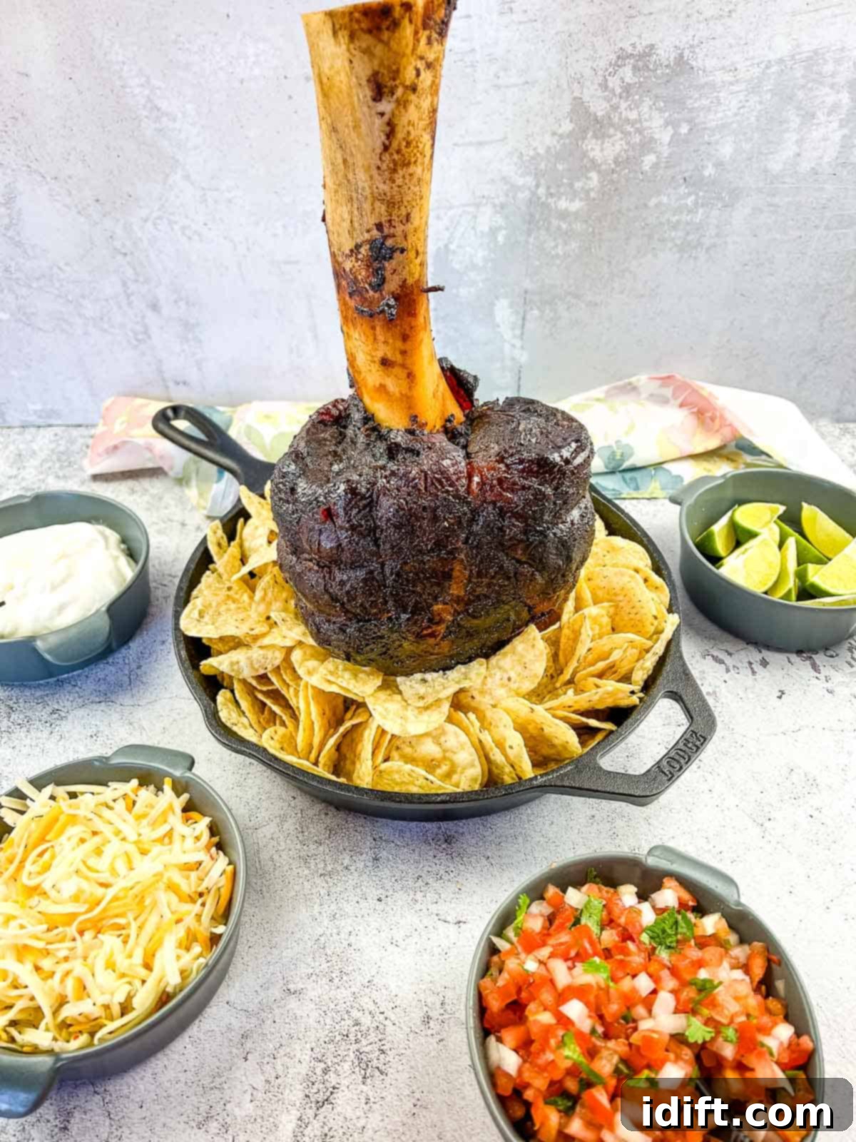Smoked Beef Shank: The Legendary Cut 2 smoked thor's hammer in a black skillet with nacho fixings around it