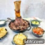 Smoked Beef Shank: The Legendary Cut 13 pulled meat from smoked thor's hammer in a black dish