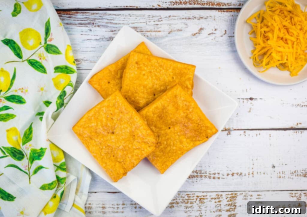 Baked Cheez-It tostada crackers cooling on a rack, ready for toppings.