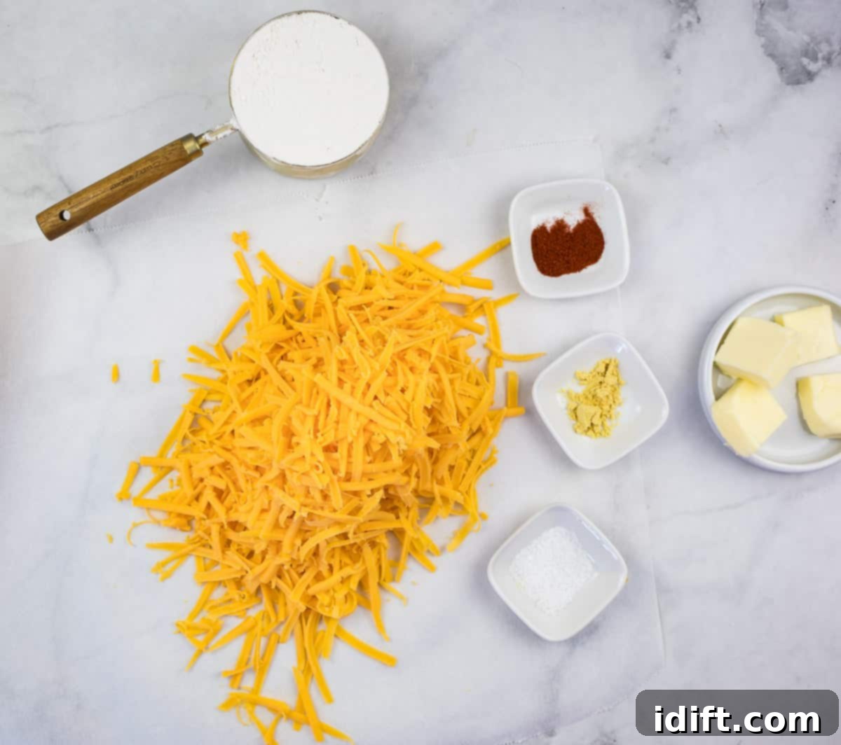 Close-up of freshly shredded cheddar cheese, ready for the Cheez-It dough.
