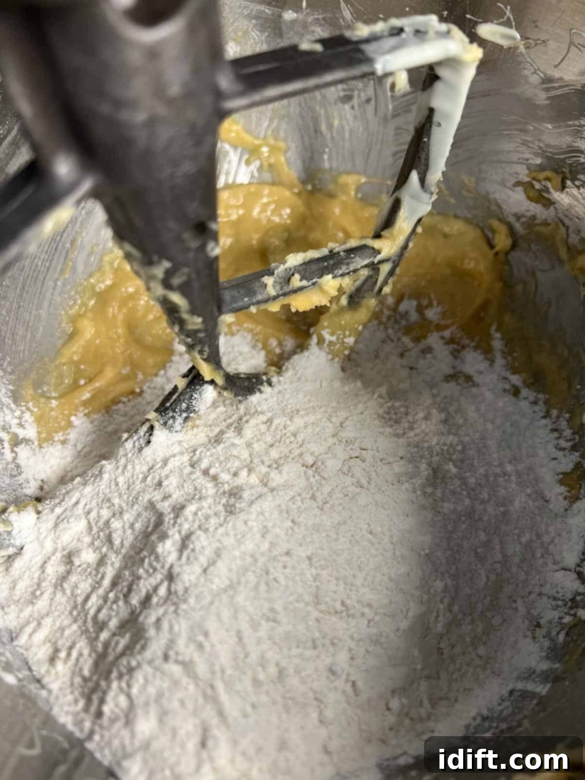 adding flour to the cookie dough