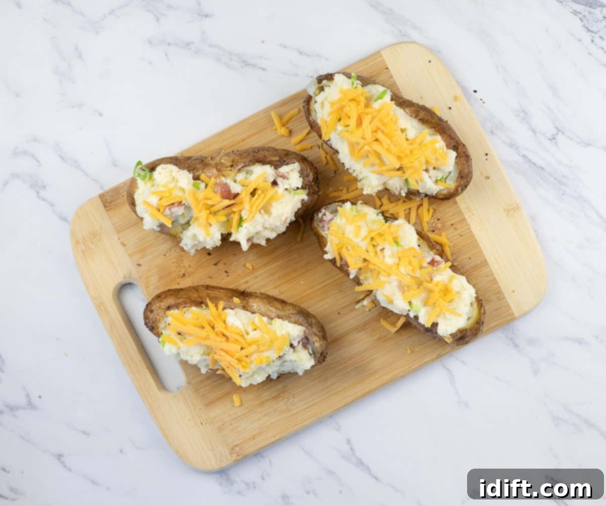 restuffed potatoes topped with cheese for the smoker