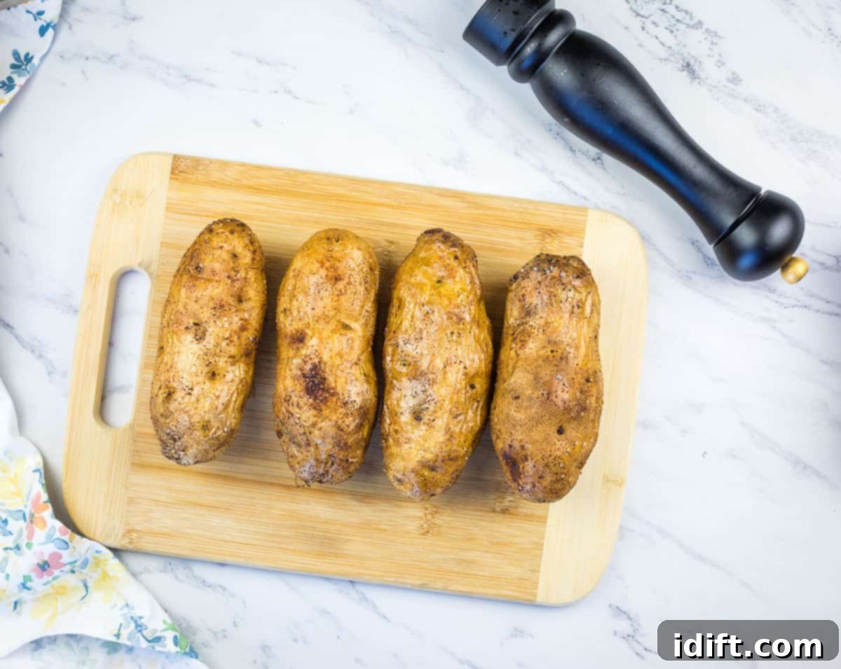 russet potatoes on a cutting board ready for the smoker