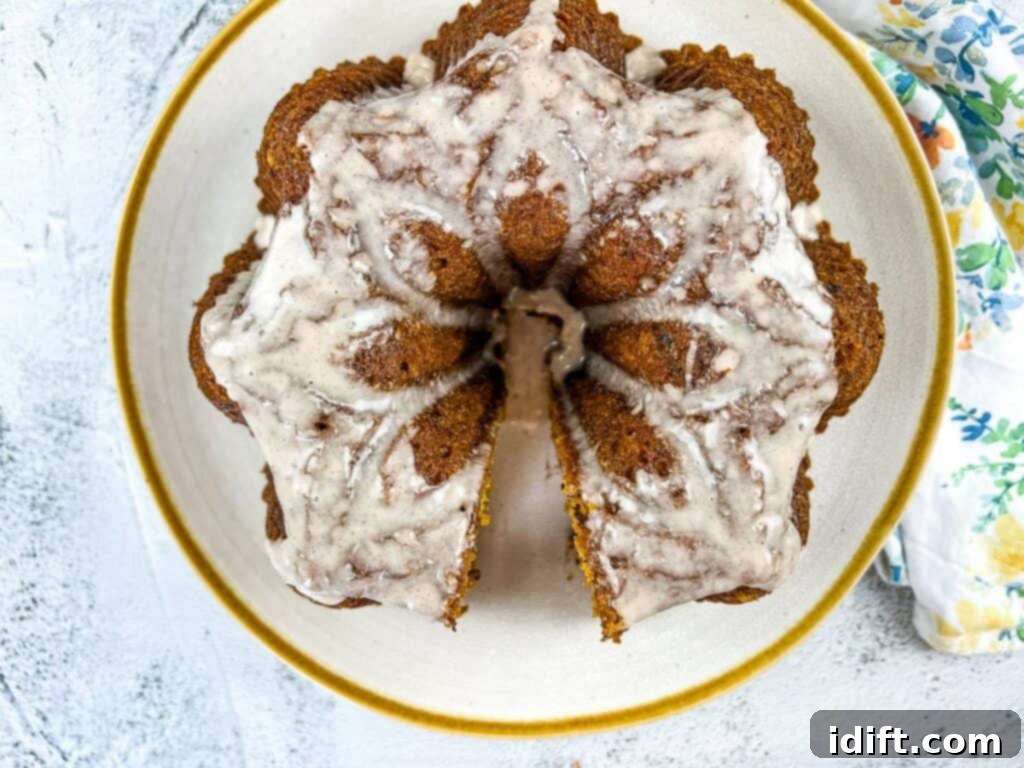 Spiced Chocolate Pumpkin Dream 3 A slice of moist pumpkin chocolate cake with glaze on a white plate