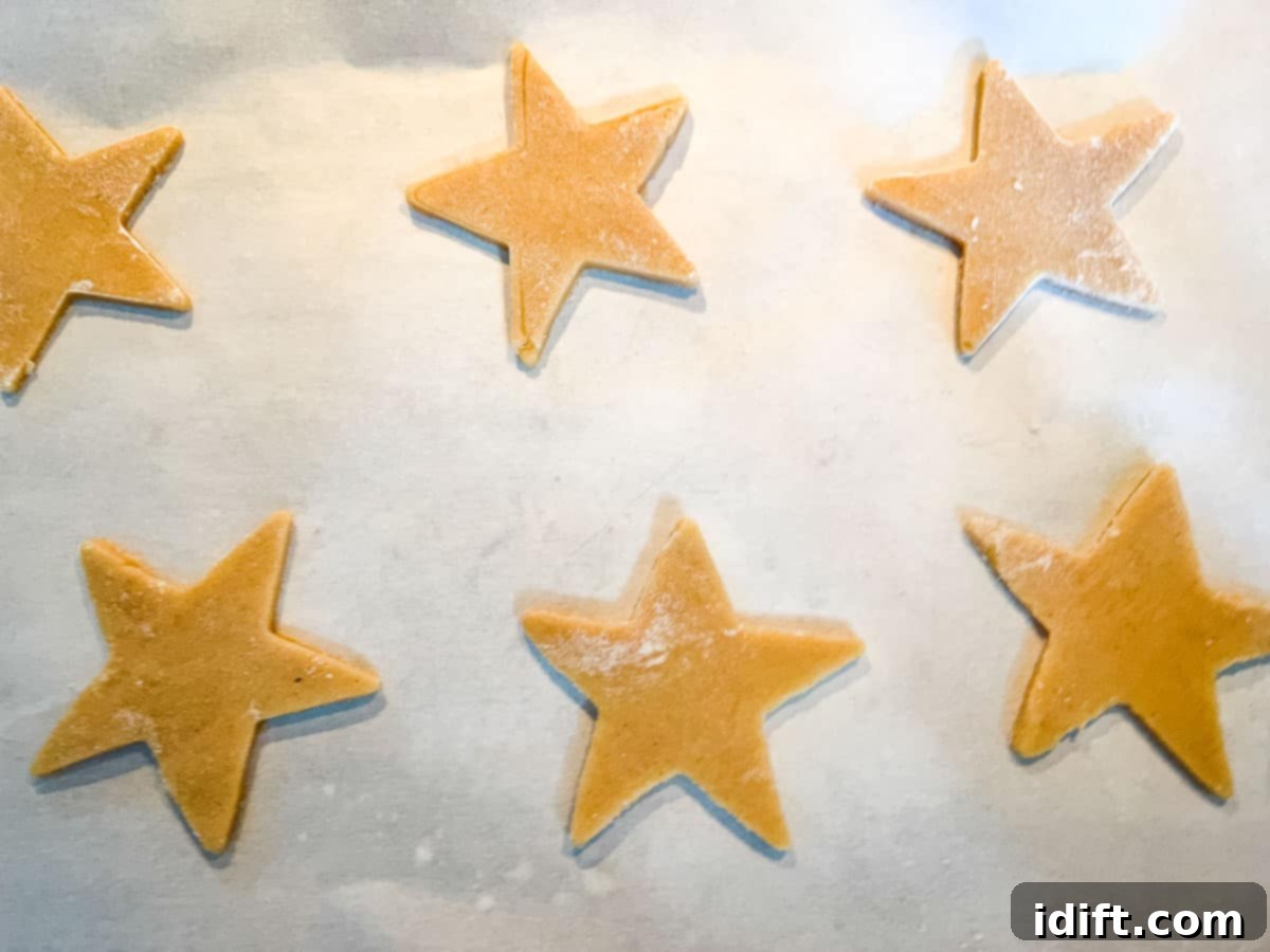 eggnog sugar cookies arranged on a baking sheet with parchment paper