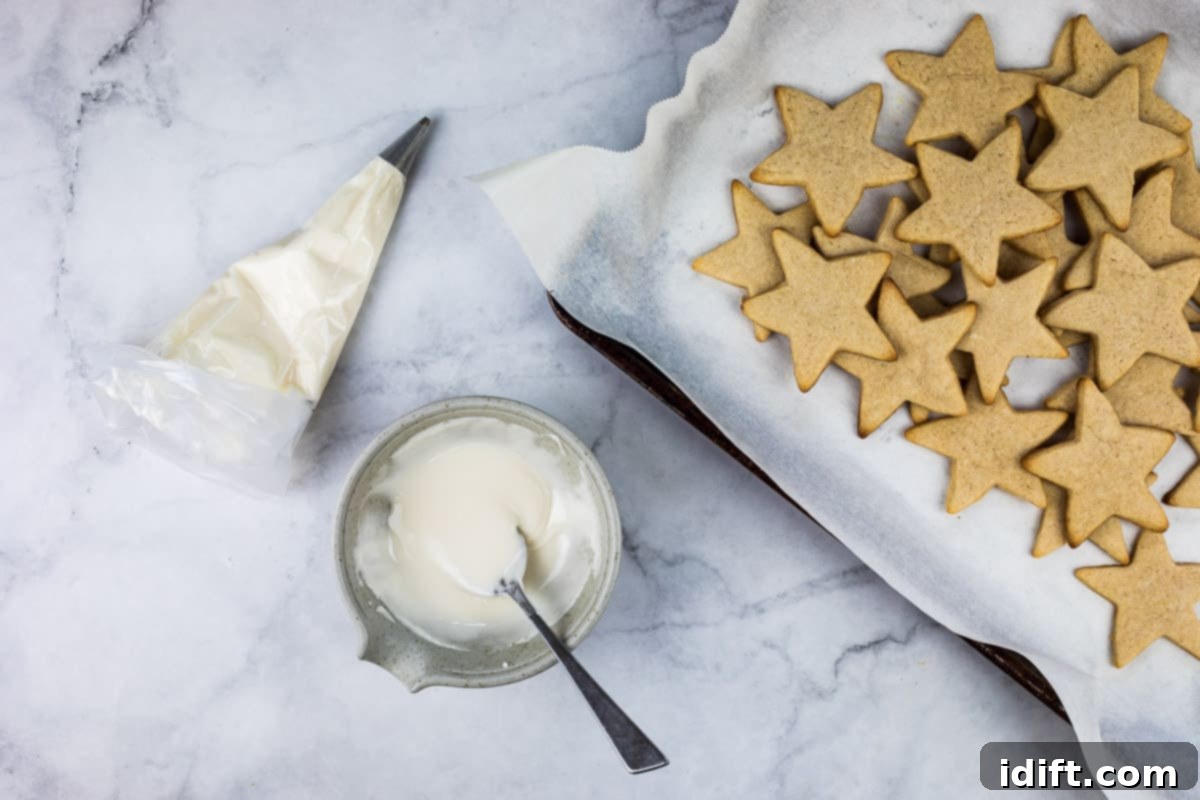 eggnog sugar cookies on a cooling rack, some already iced and decorated